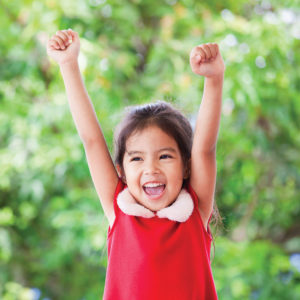 Child with arms raised
