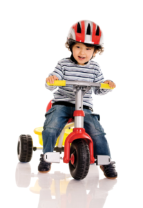 child on tricycle