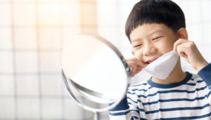 child looking into mirror